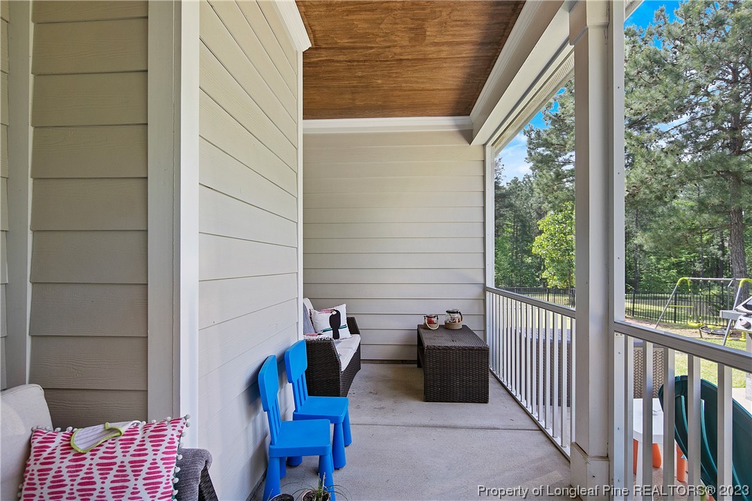164 Valley Stream Road Spring Lake, NC 28390 - Photo 44 of 49 a view of balcony with two chairs and a potted plant