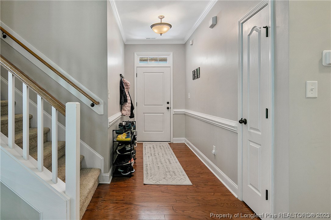 164 Valley Stream Road Spring Lake, NC 28390 - Photo 6 of 49 a view of a hallway with wooden floor and staircase