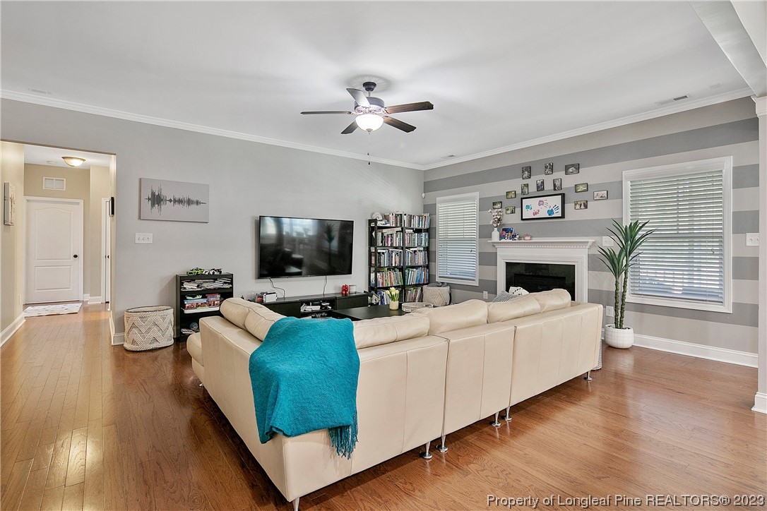 164 Valley Stream Road Spring Lake, NC 28390 - Photo 10 of 49 a living room with furniture a flat screen tv and a fireplace