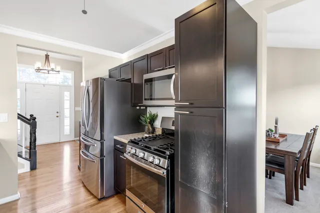 a metallic refrigerator freezer sitting in a kitchen