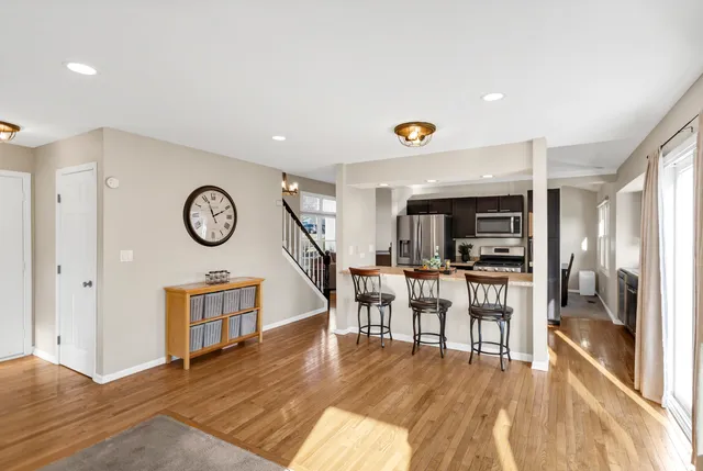 a view of a dining room with furniture a kitchen and chandelier