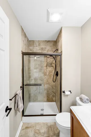 a bathroom with a sink toilet and shower