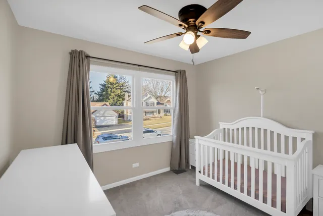 a bedroom with furniture and a large window