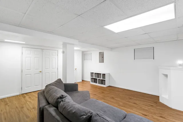 a living room with furniture and kitchen view