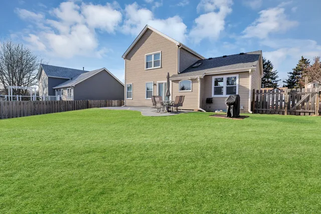 a house view with a sitting space and garden
