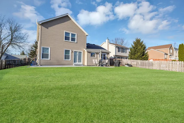 a front view of house with yard and green space