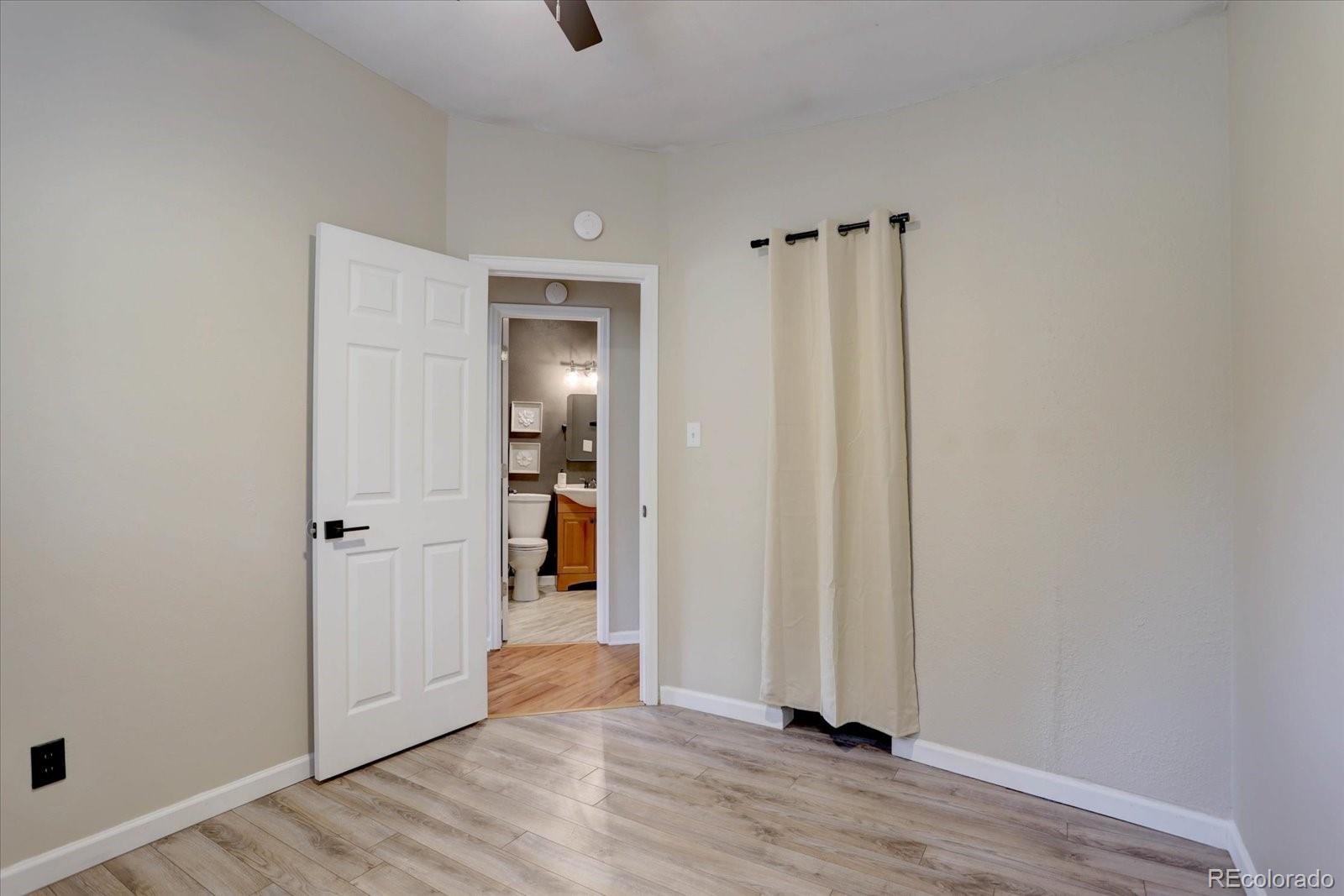 9288 Krashin Drive Conifer, CO 80433 - Photo 12 of 34 a view of a hallway with wooden floor and closet area