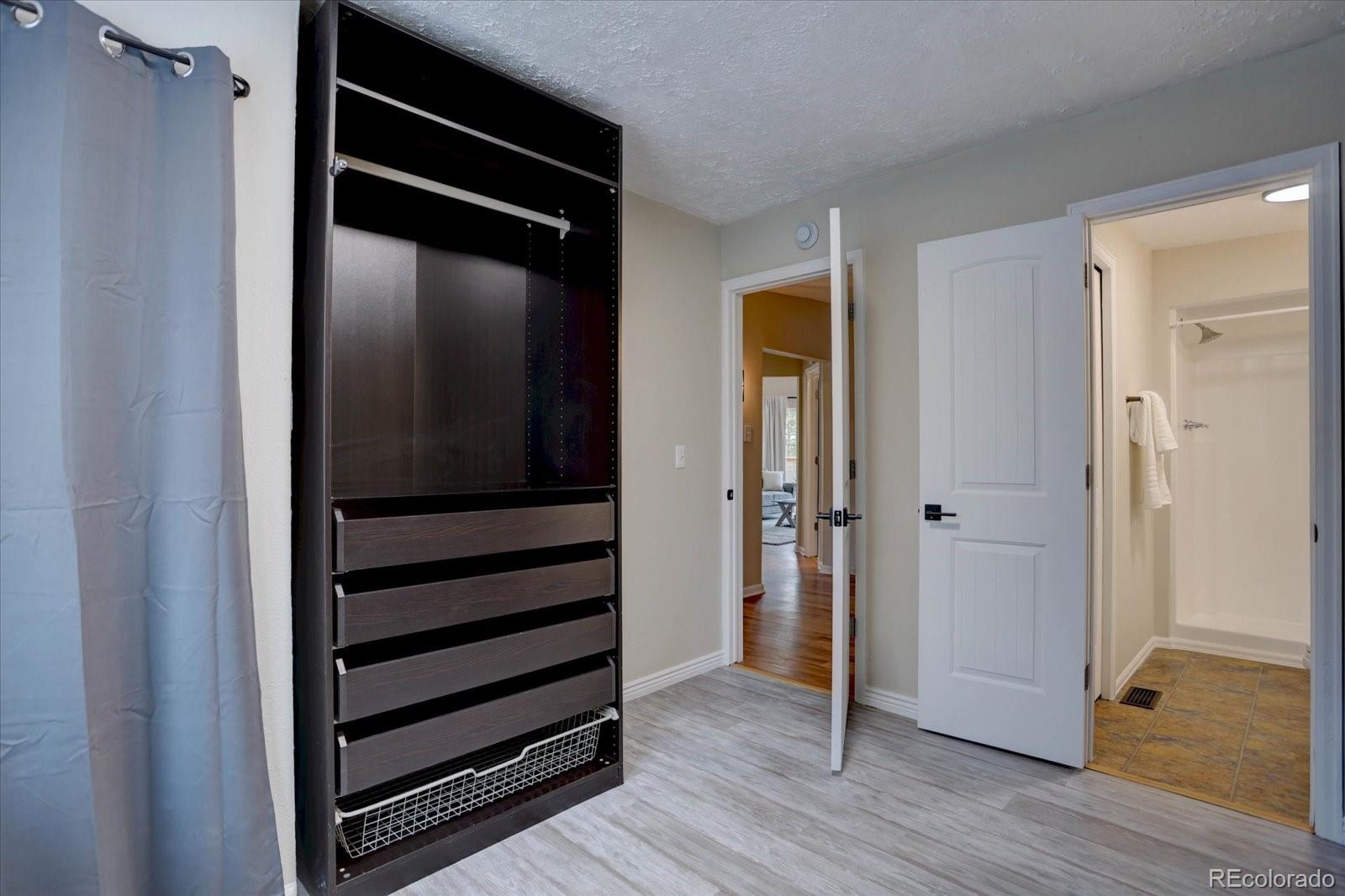 9288 Krashin Drive Conifer, CO 80433 - Photo 17 of 34 a view of closet area with wooden floor