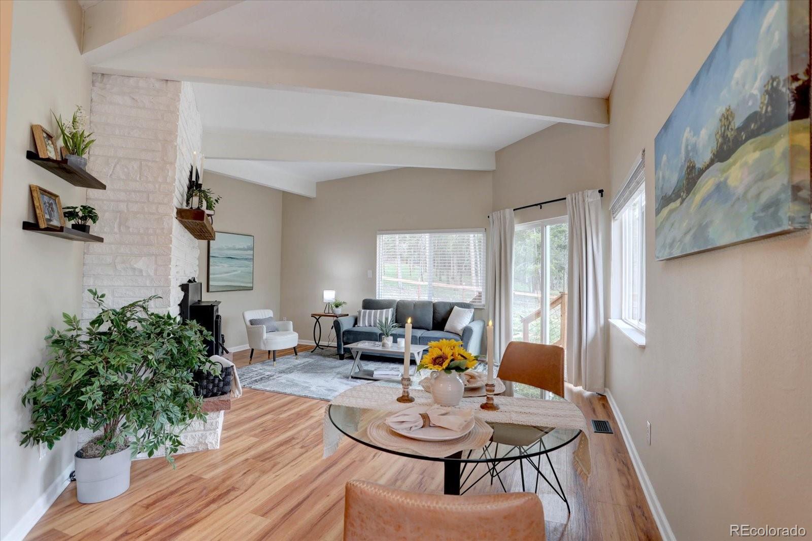 9288 Krashin Drive Conifer, CO 80433 - Photo 2 of 34 a living room with furniture and a potted plant