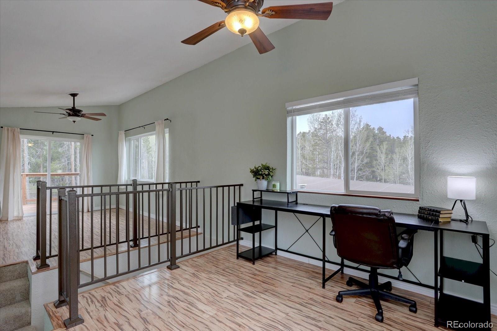 9288 Krashin Drive Conifer, CO 80433 - Photo 21 of 34 a workspace with wooden floor and a window