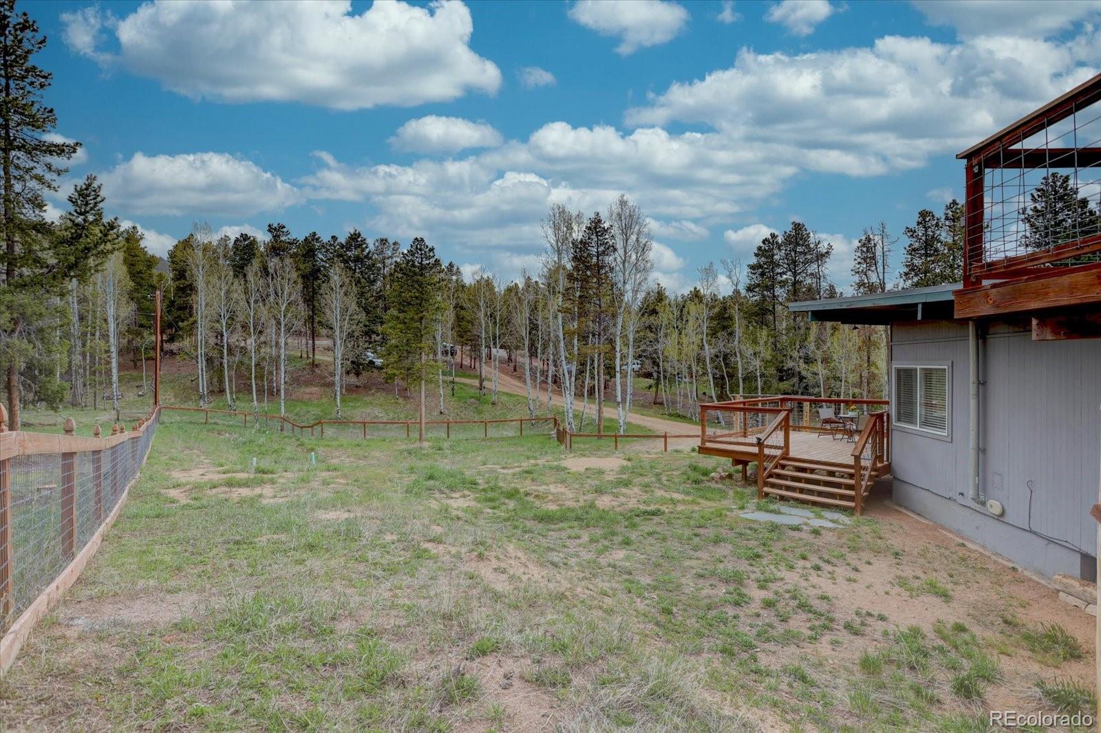 9288 Krashin Drive Conifer, CO 80433 - Photo 25 of 34 a view of a bench in a backyard