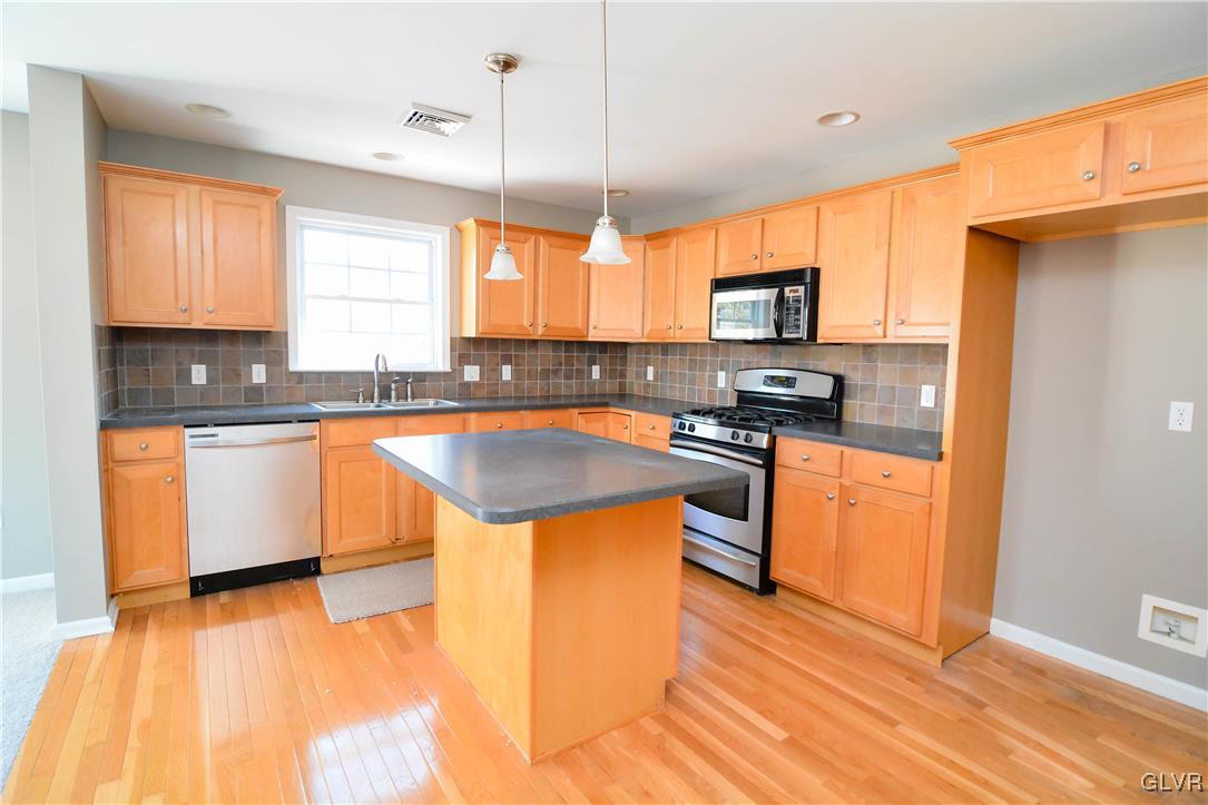 4190 Ross Road Bethlehem, PA 18020 - Photo 3 of 44 a kitchen with stainless steel appliances granite countertop a sink a stove and a refrigerator
