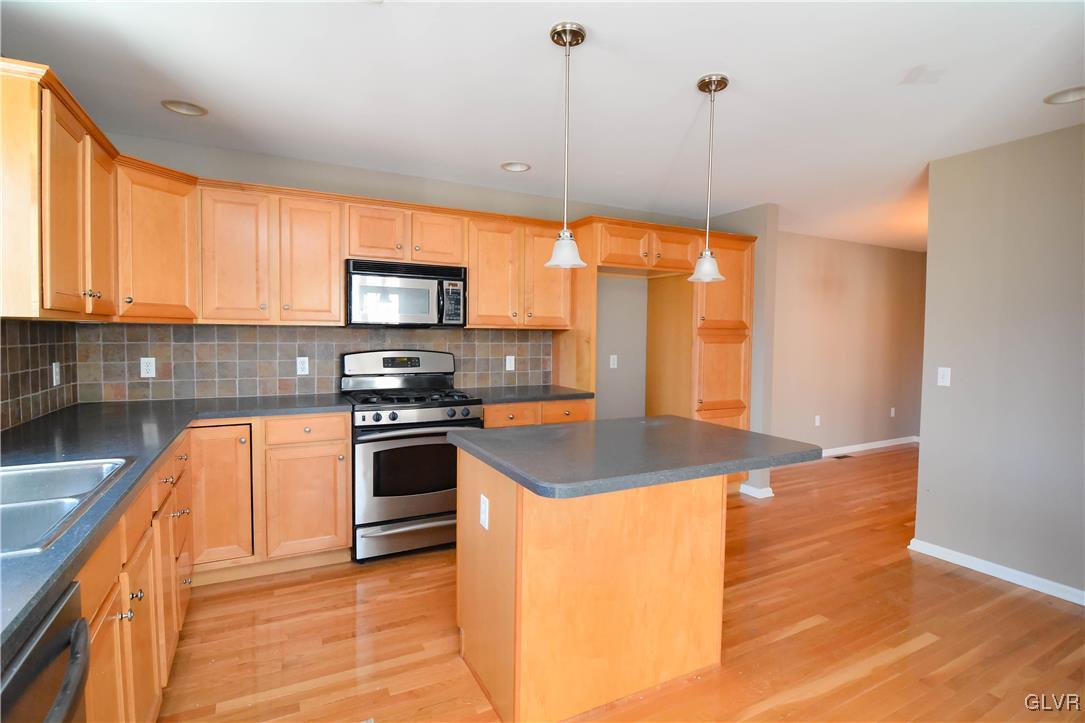 4190 Ross Road Bethlehem, PA 18020 - Photo 7 of 44 a kitchen with stainless steel appliances granite countertop a stove a sink and a microwave