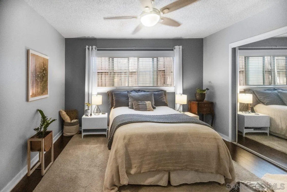 720 West Lewis Street, Unit 6 San Diego, CA 92103 - Photo 4 of 8 a bedroom with a bed and wooden floor