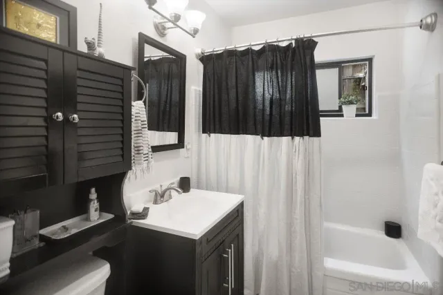 a bathroom with a sink a mirror and shower