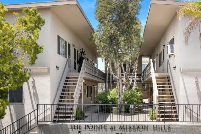 a view of a house with iron fence