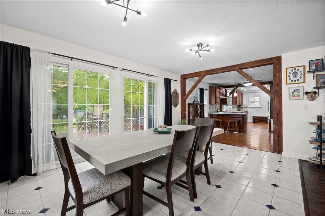 27258 Cook Road Olmsted Falls, OH 44138 - Photo 6 of 44 Tiled flooring with accent squares, exposed wood beams, and a modern ceiling light fixture