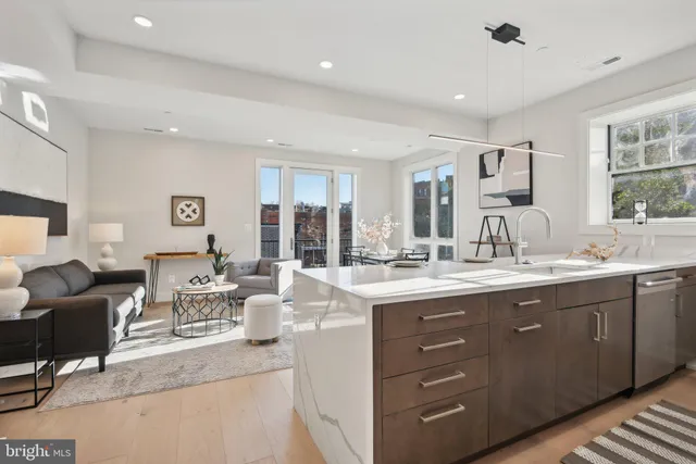 a living room with kitchen island granite countertop furniture and fireplace