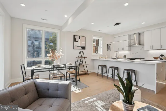 a living room with fireplace furniture and a dining table