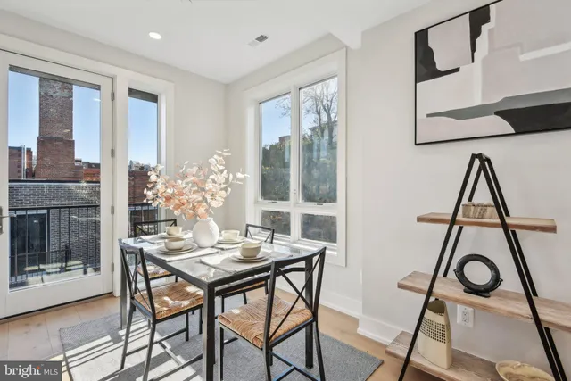 a view of a workspace with furniture and window