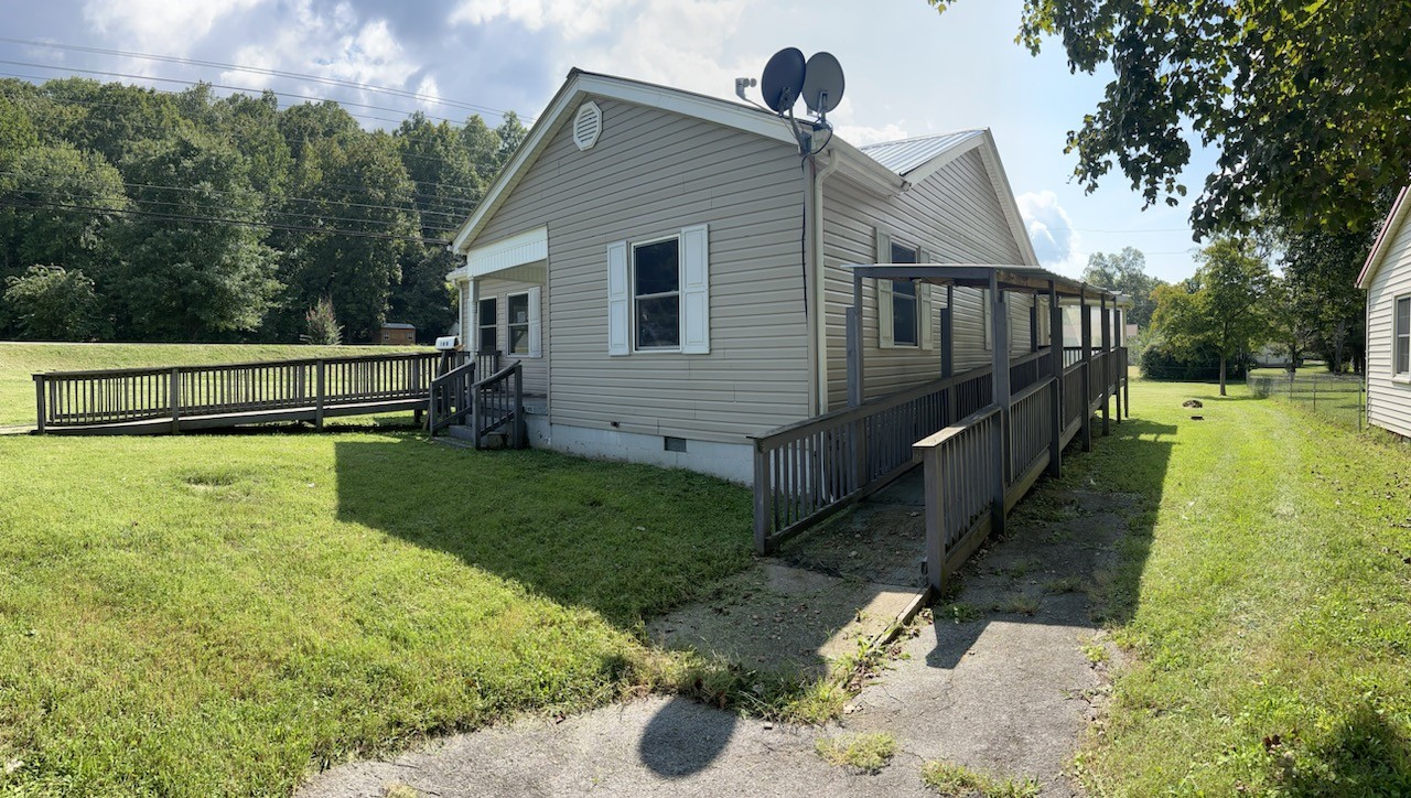 100 Park Circle Waverly, TN 37185 - Photo 2 of 32 a view of backyard with wooden fence and a bench