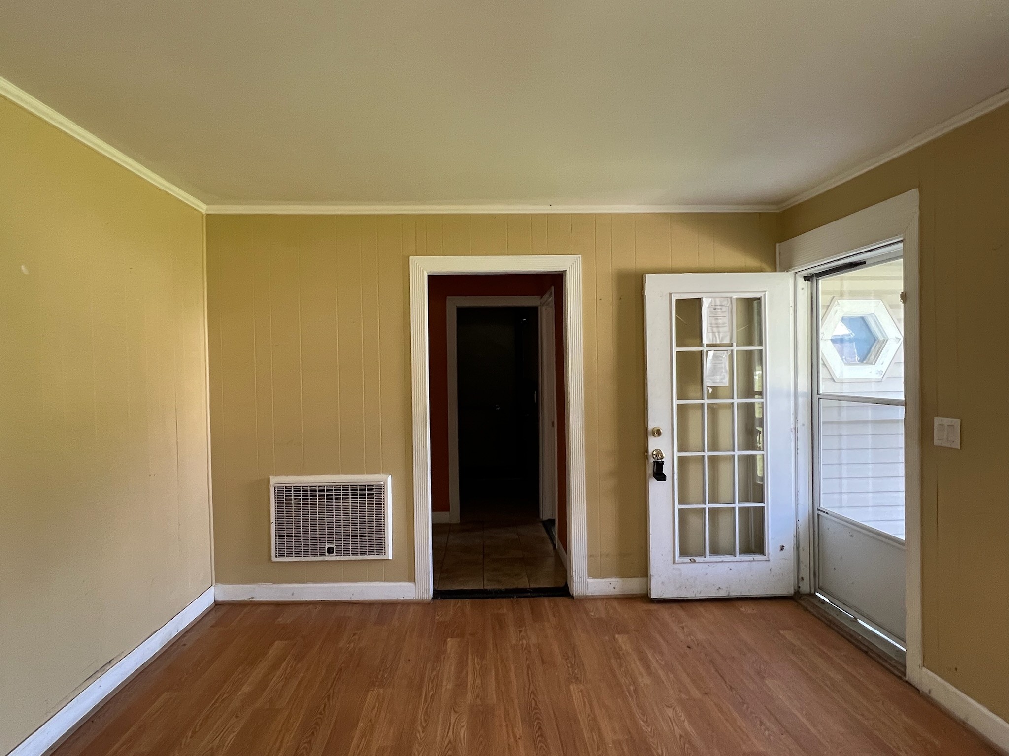 100 Park Circle Waverly, TN 37185 - Photo 3 of 32 an empty room with wooden floor and windows