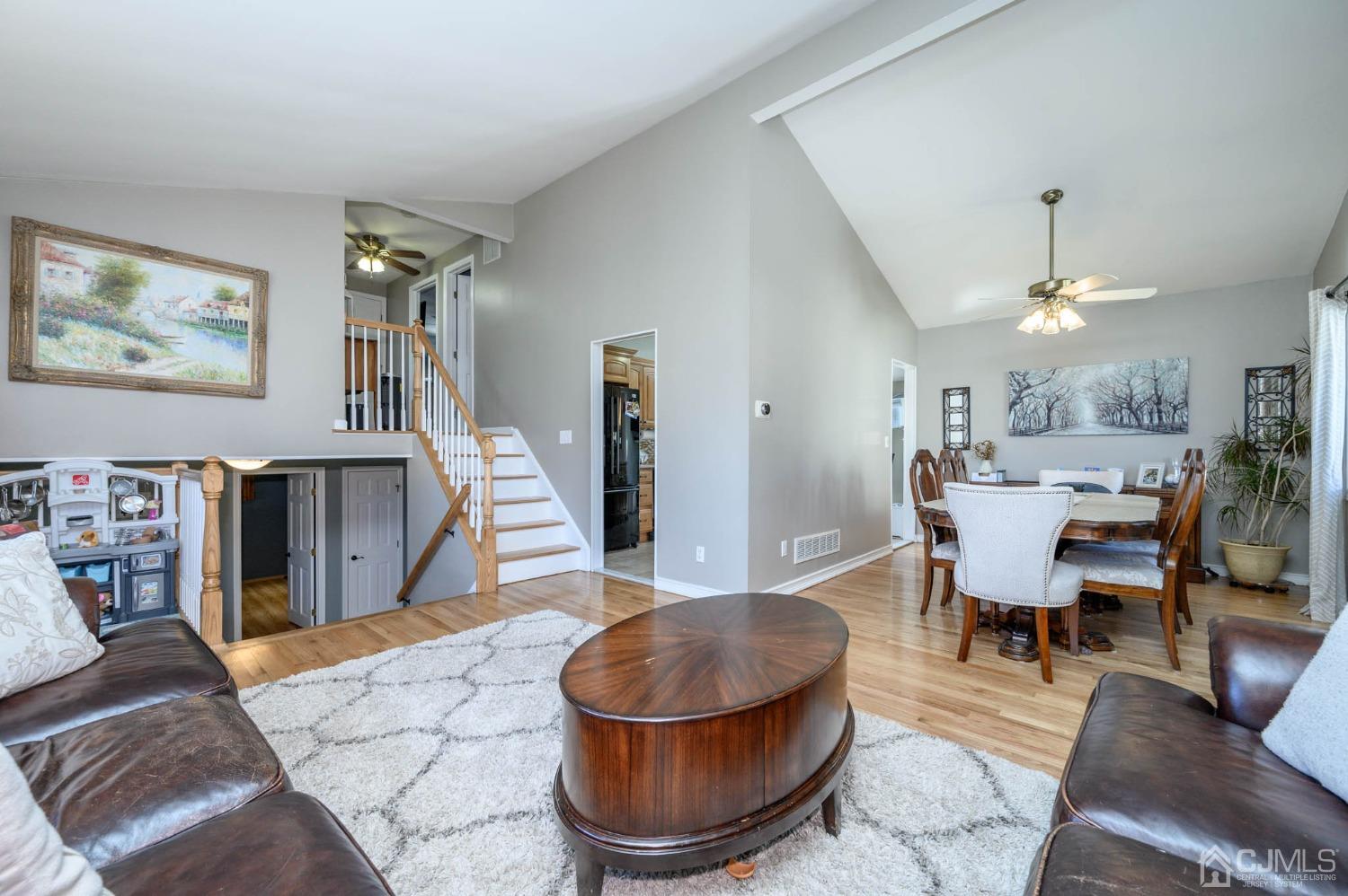 44 Owens Road Old Bridge, NJ 08857 - Photo 14 of 48 a living room with furniture a dining table and a chandelier