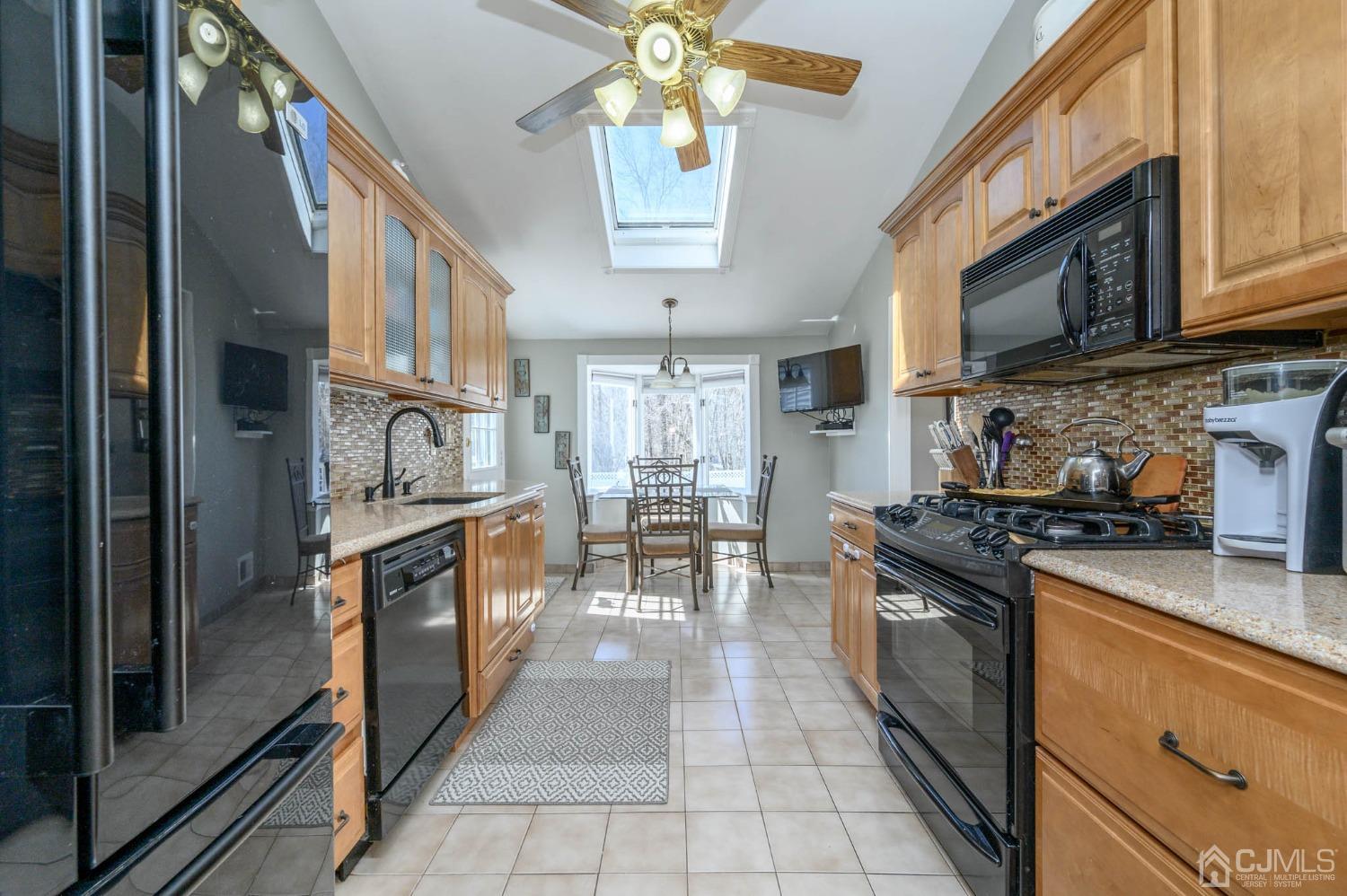 44 Owens Road Old Bridge, NJ 08857 - Photo 17 of 48 a kitchen with stainless steel appliances granite countertop a stove a sink and a refrigerator