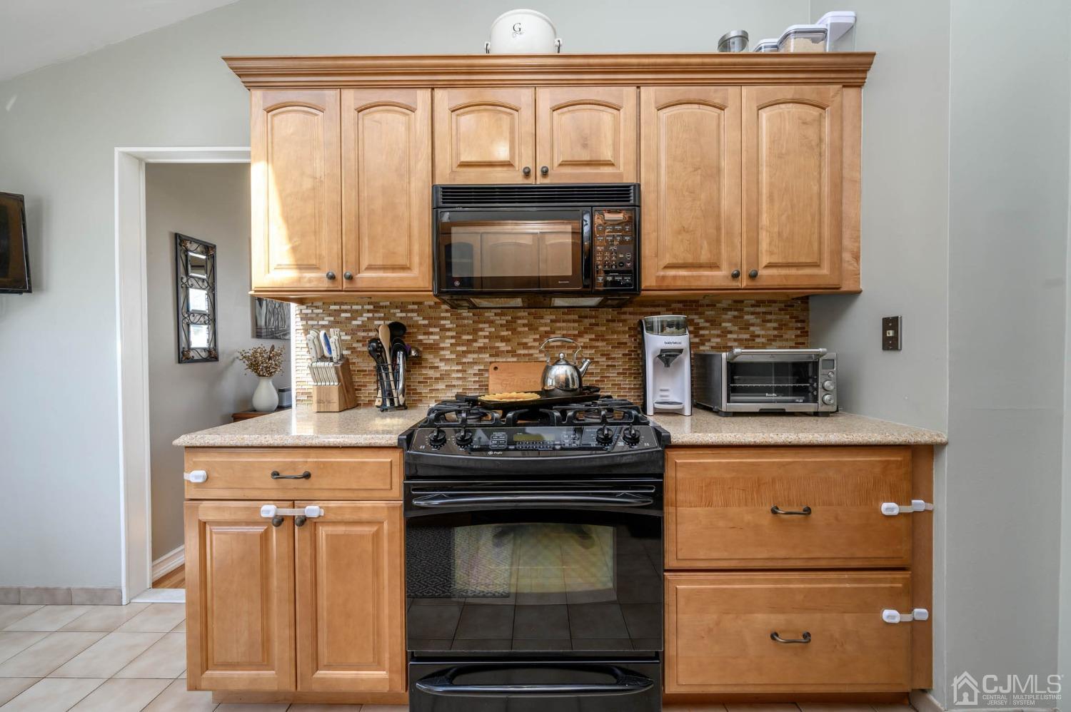 44 Owens Road Old Bridge, NJ 08857 - Photo 20 of 48 a kitchen with granite countertop white cabinets and stainless steel appliances