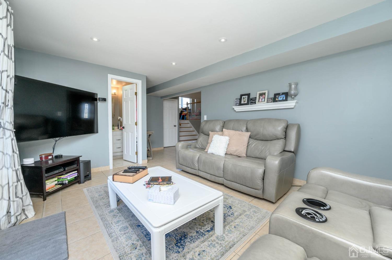 44 Owens Road Old Bridge, NJ 08857 - Photo 7 of 48 a living room with furniture and a flat screen tv