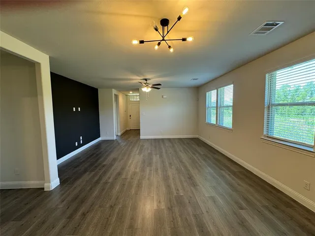 a view of an empty room and a window