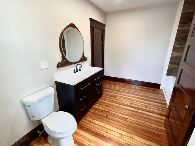 a bathroom with a sink toilet and a mirror