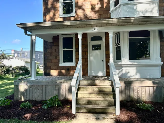 a front view of a house with a garden