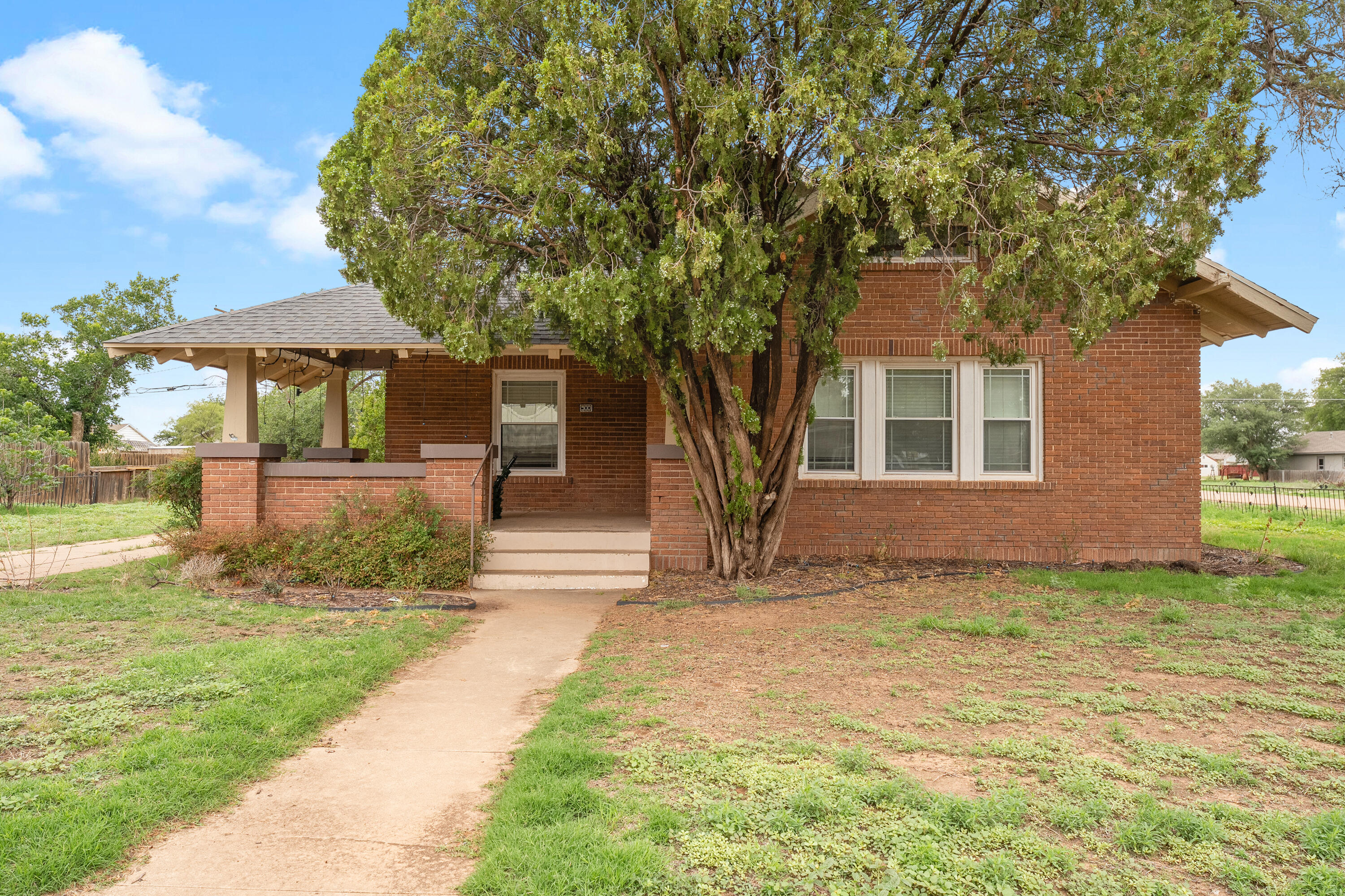 500 West Garza Street Slaton, TX 79364 - Photo 1 of 24 a front view of a house with a garden
