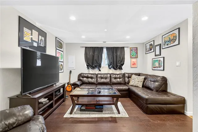 a living room with furniture and a bookshelf