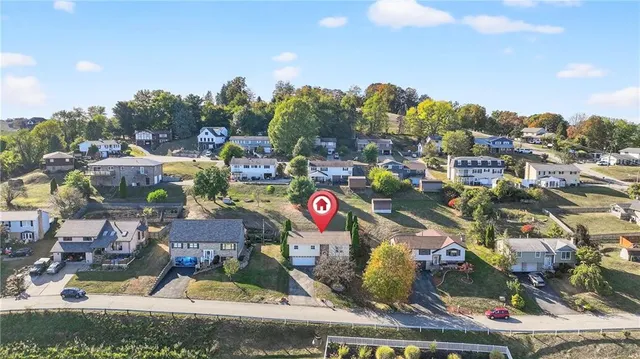 a kitchen with stainless steel appliances granite countertop a stove top oven a refrigerator a sink and dishwasher with wooden floor