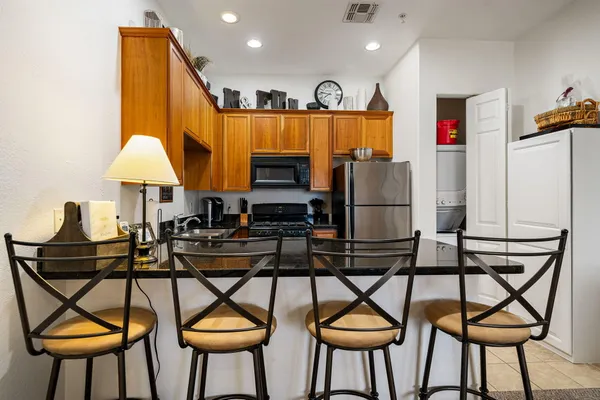 a view of a dining room with furniture and a chandelier