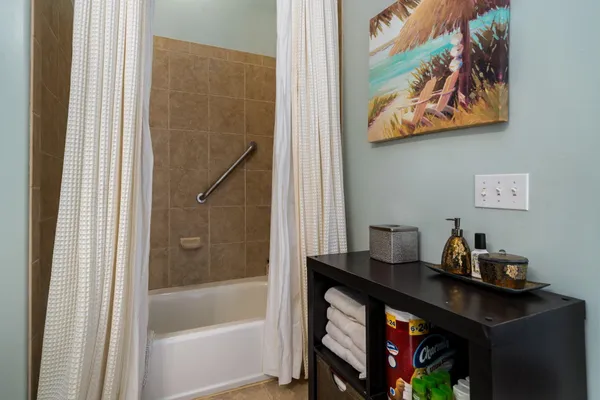 a bath room with a desk and a window
