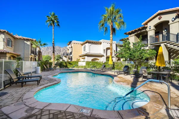 a swimming pool with outdoor seating and yard