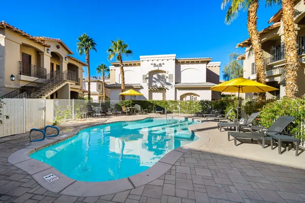 a view of a patio with swimming pool table and chairs