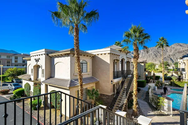 a view of a house with balcony and outdoor space