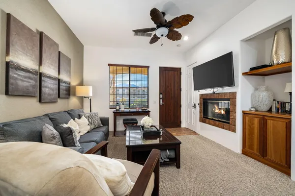 a living room with furniture a fireplace and a flat screen tv