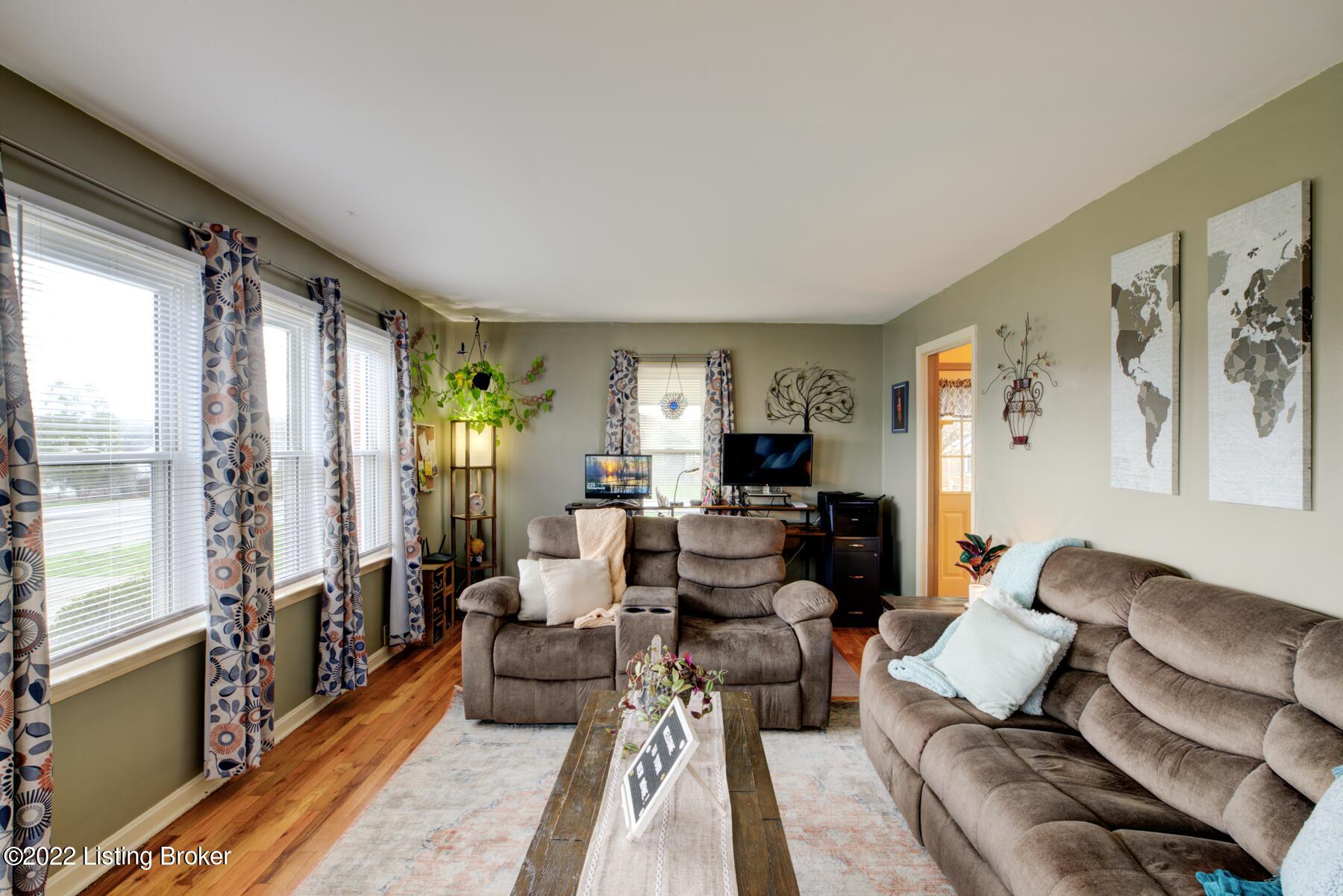 Spacious living room with refinished hardwood floors