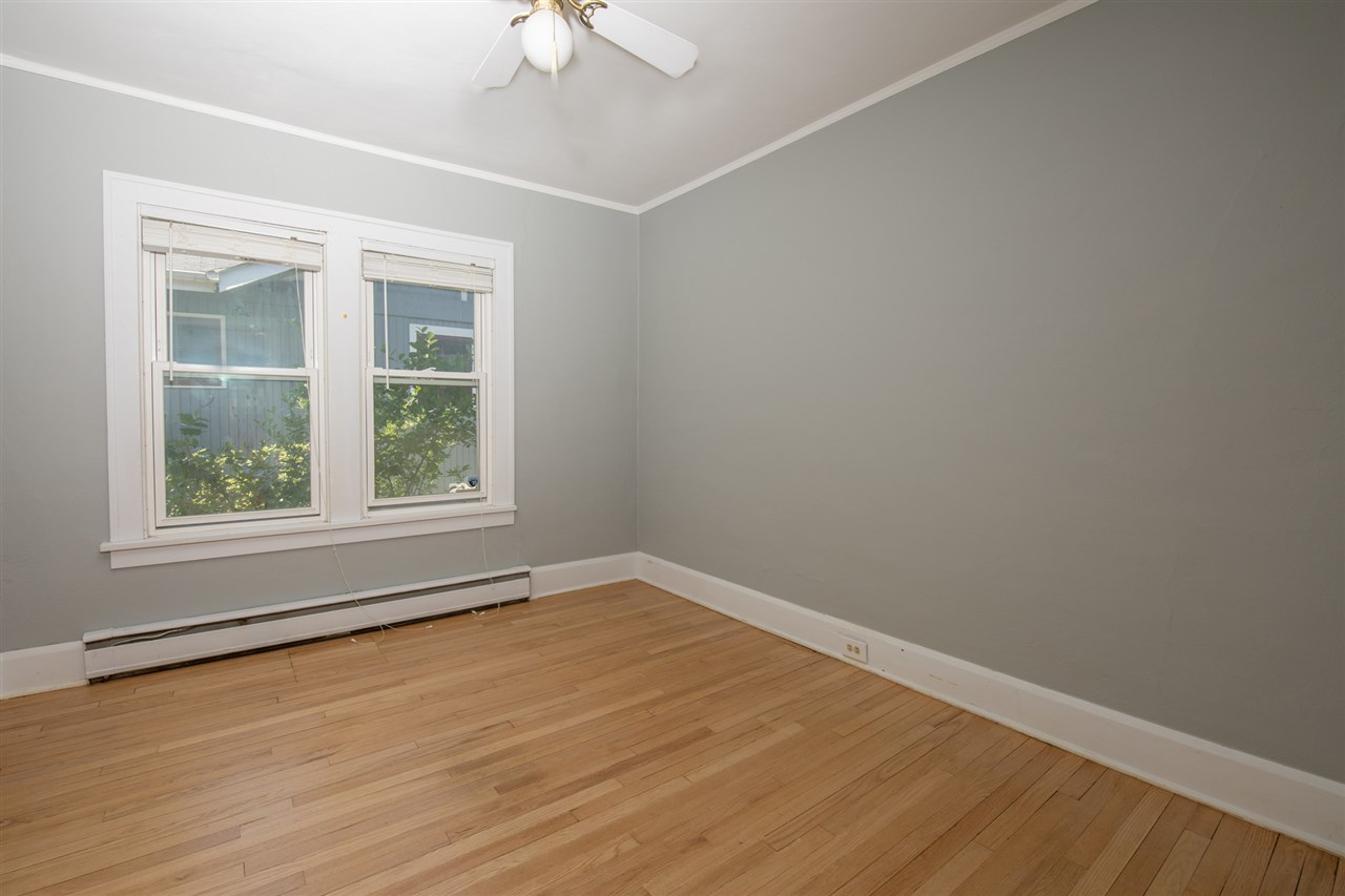 1719 Post Avenue Rockford, IL 61103 - Photo 12 of 29 wooden floor in an empty room with a window