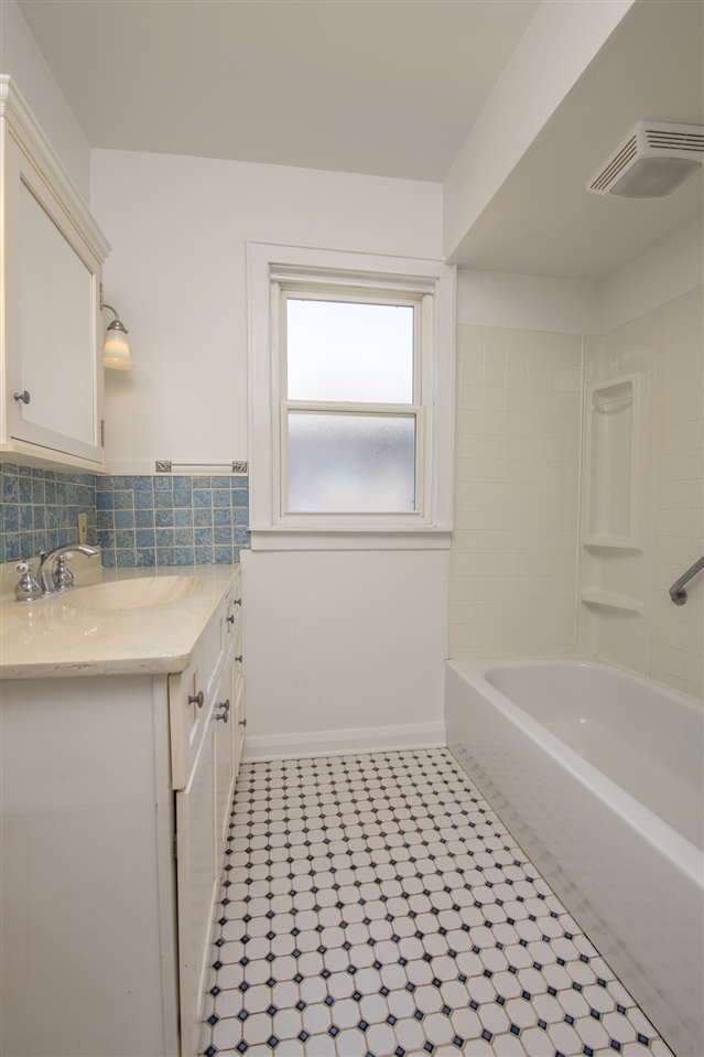 1719 Post Avenue Rockford, IL 61103 - Photo 13 of 29 a bathroom with a sink a mirror and a bathtub