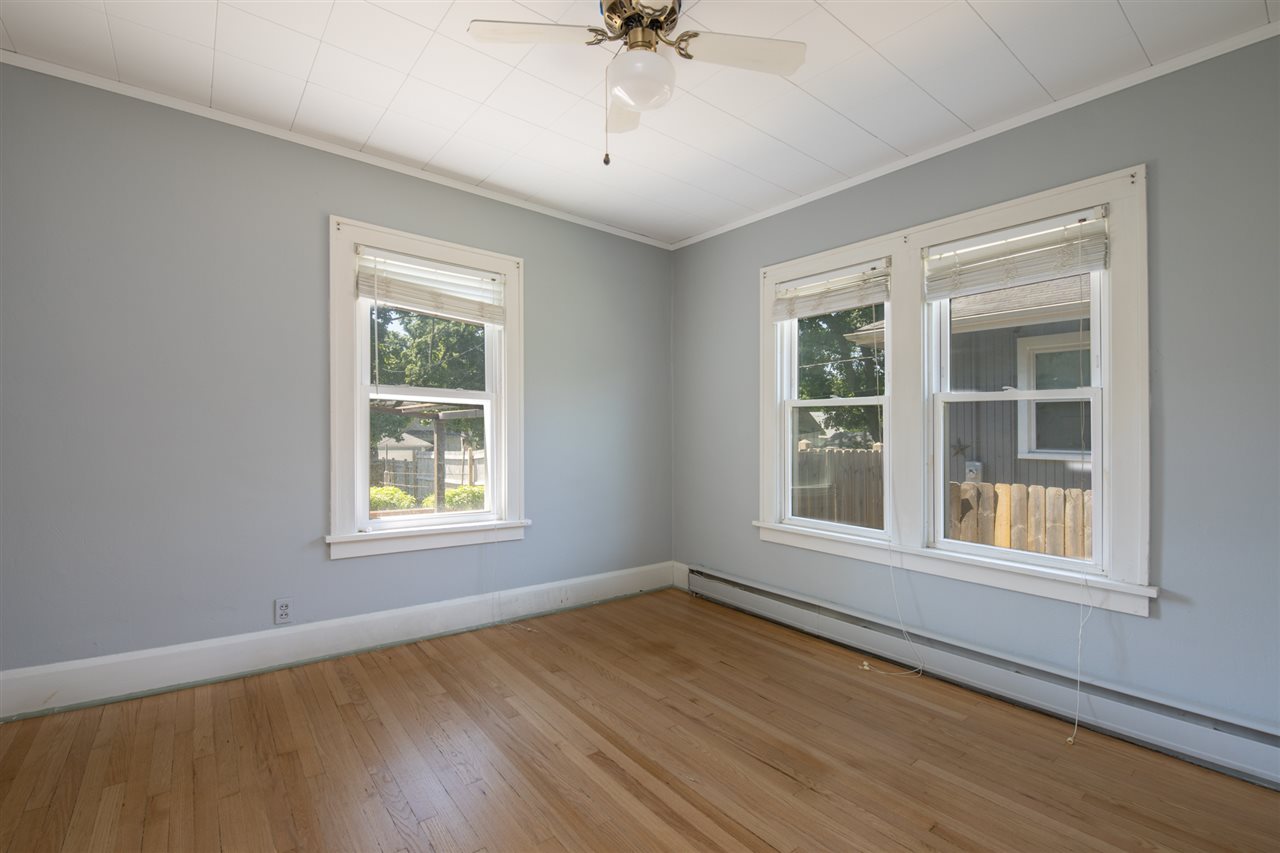 1719 Post Avenue Rockford, IL 61103 - Photo 14 of 29 an empty room with wooden floor and windows