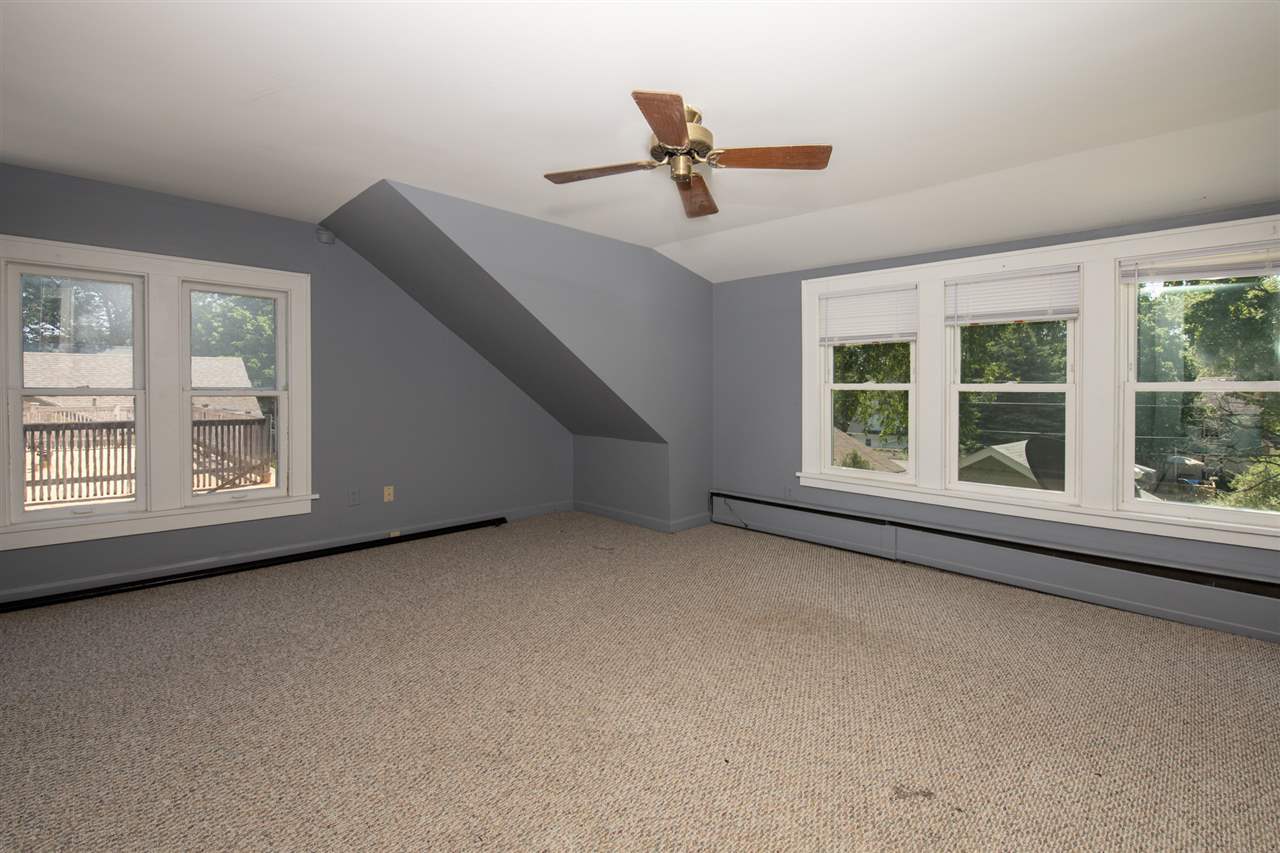 1719 Post Avenue Rockford, IL 61103 - Photo 16 of 29 an empty room with windows and ceiling fan