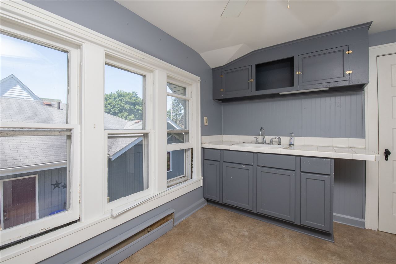 1719 Post Avenue Rockford, IL 61103 - Photo 18 of 29 a kitchen with stainless steel appliances granite countertop a stove microwave and sink