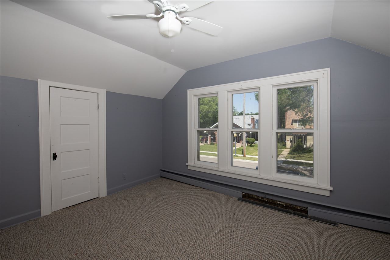 1719 Post Avenue Rockford, IL 61103 - Photo 21 of 29 an empty room with chandelier fan and windows