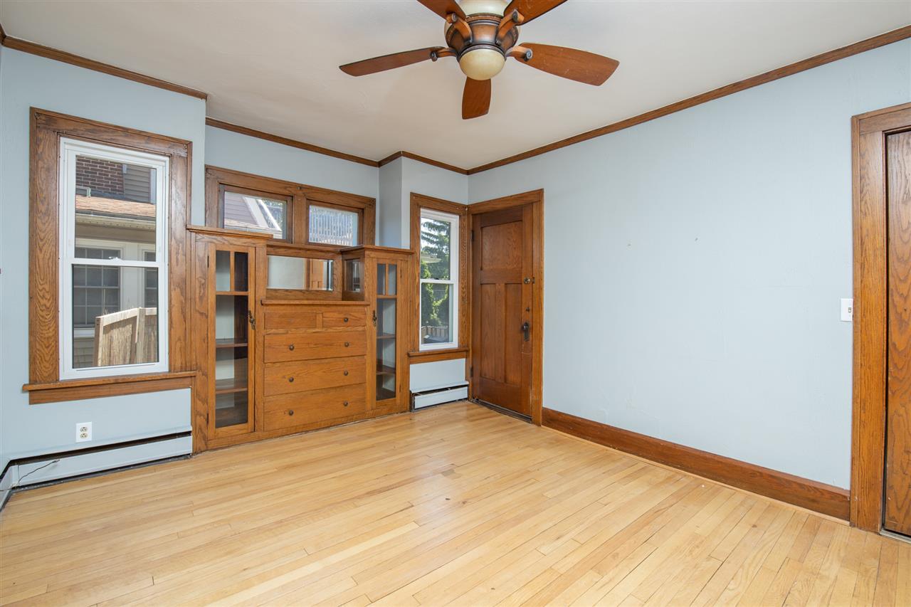 1719 Post Avenue Rockford, IL 61103 - Photo 7 of 29 a view of a livingroom with a cabinet and a chandelier fan